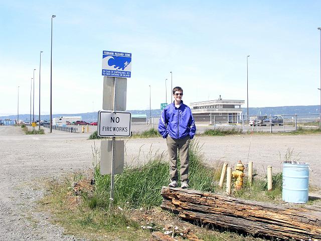 P6230173.JPG - A sign at the end of Homer Spit reading "Tsunami Hazard Zone - In case of earthquake go to high ground or inland." The Good Friday Earthquake of 1964 destroyed this area.