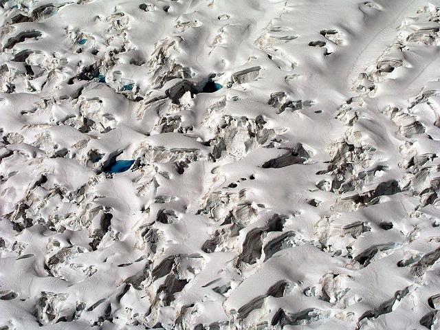 P6250239.JPG - An aerial view of a glacier. The blue spots are softer areas where the snow on top has melted.