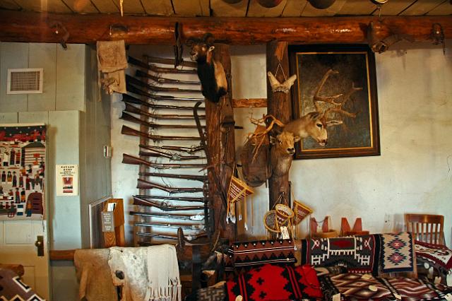 IMG_3749.JPG - Collection of guns, trophies, and Navajo rugs at the Hubbell Trading Post.